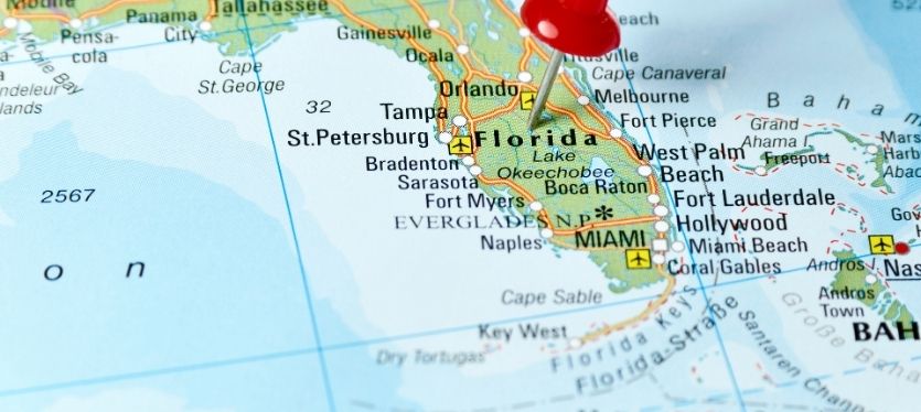 A red map pin symbolizing a specific location in Florida, set against a light background