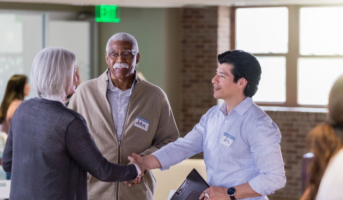 Two professionals shake hands in an HOA, representing a connection or alliance.