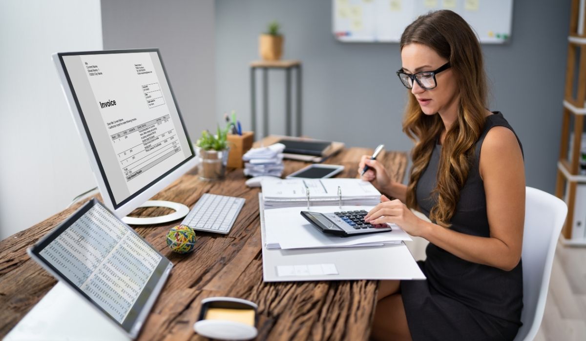 Woman with glasses working on her laptop in a cozy environment