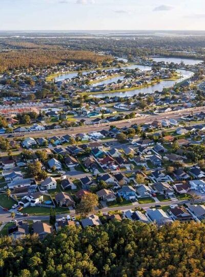 Aerial view of a suburb in Brisbane, showing houses and streets in a quiet, green residential setting.