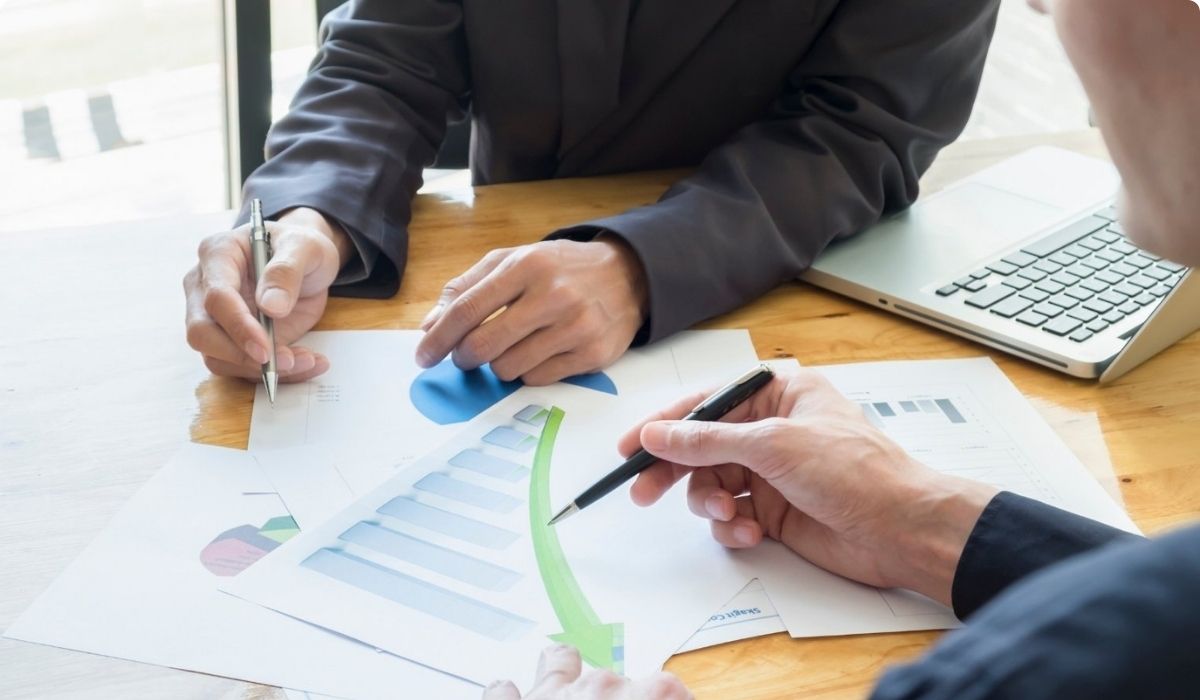 Two professionals collaborate on a business plan for multifamily investment in Orlando.