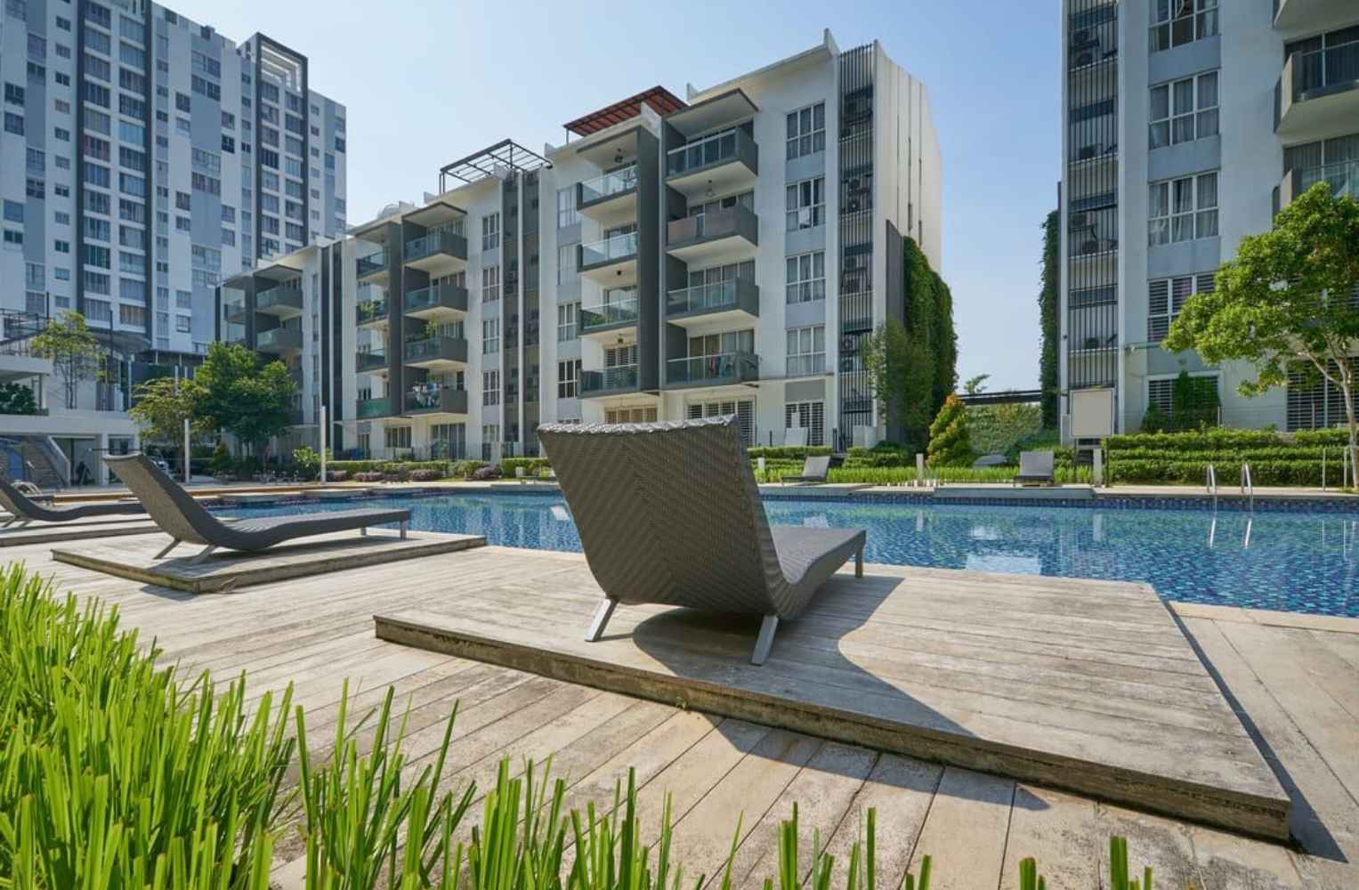 La piscina del complejo de apartamentos está rodeada de césped verde, ideal para relajarse en Florida.