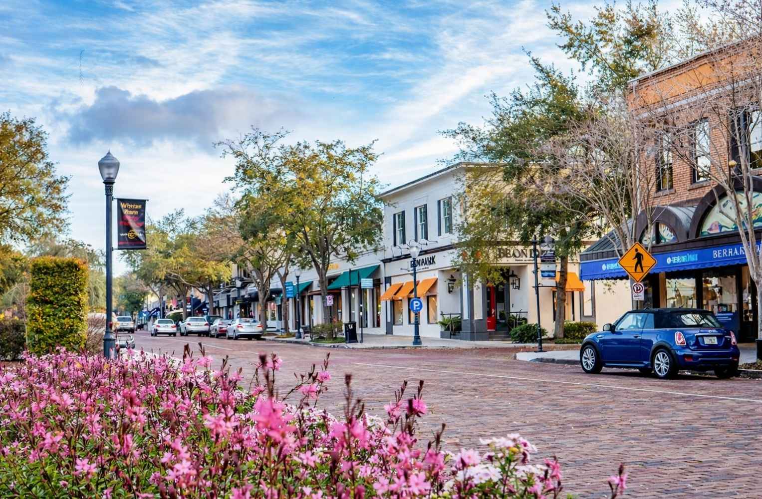 Calle con tiendas y flores en el centro de un vecindario familiar en Orlando.