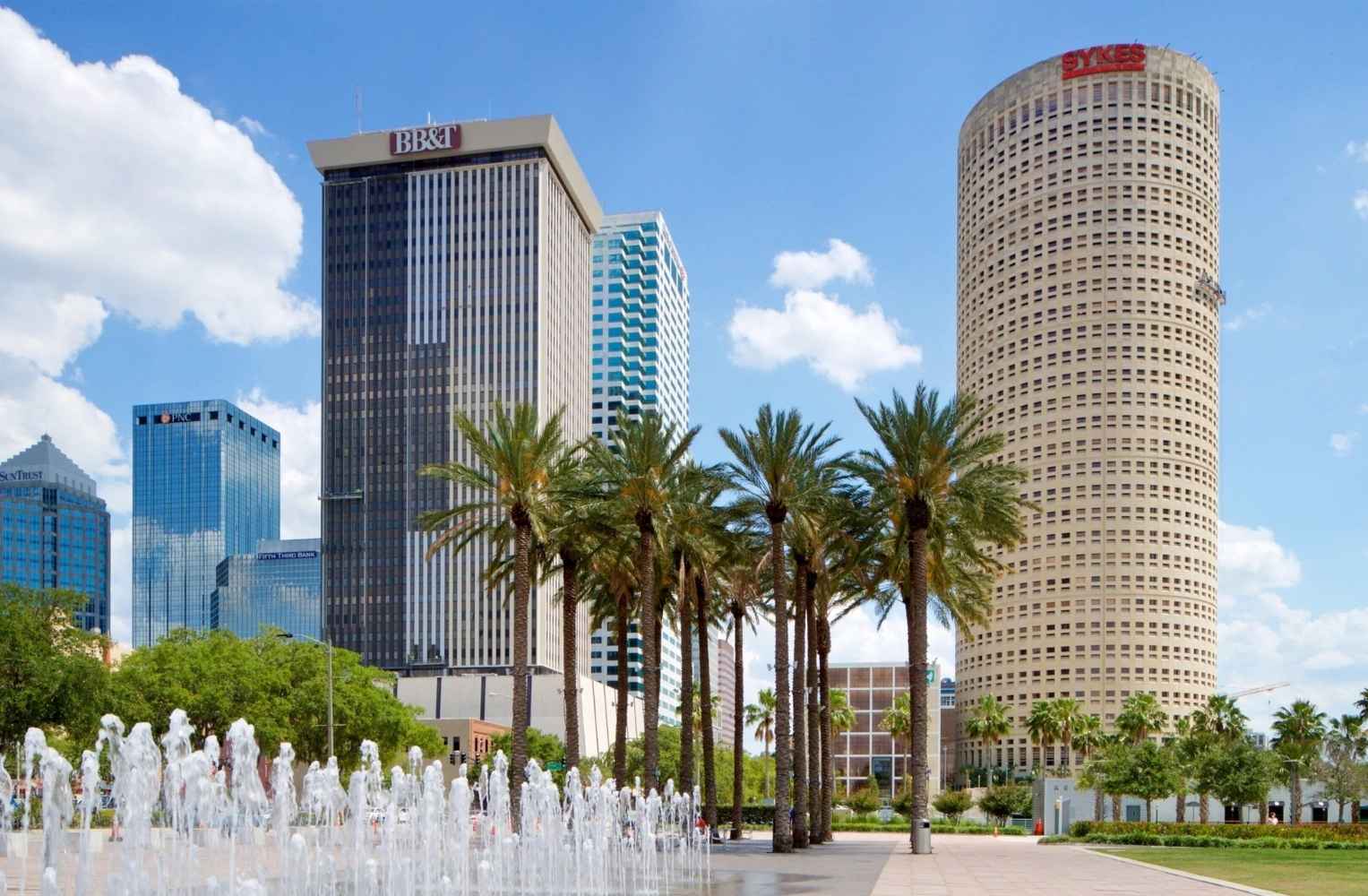 Fuente de agua y plaza pública en el Downtown de Tampa rodeada de rascacielos corporativos como el Rivergate Tower.