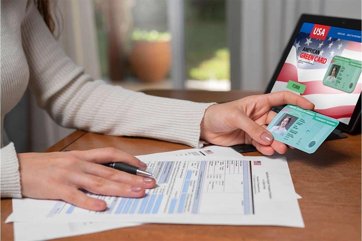 Persona sosteniendo green card frente a documentos para construir historial crediticio en EE.UU.